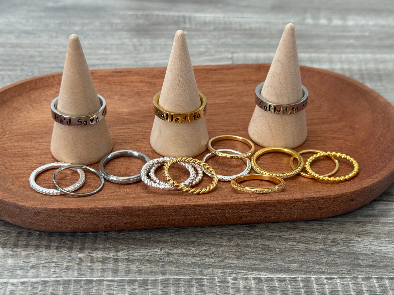 stack of three silver rings on a finger