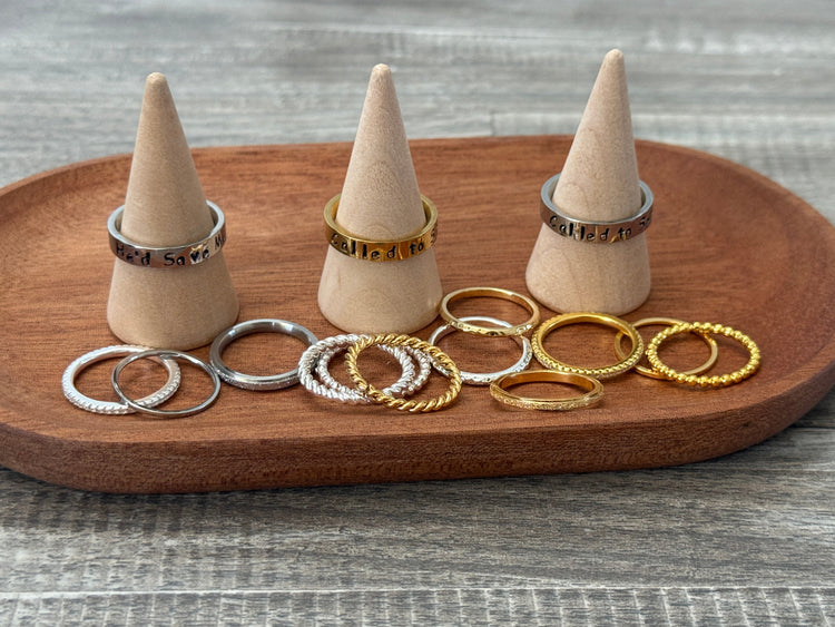 stack of three silver rings on a finger