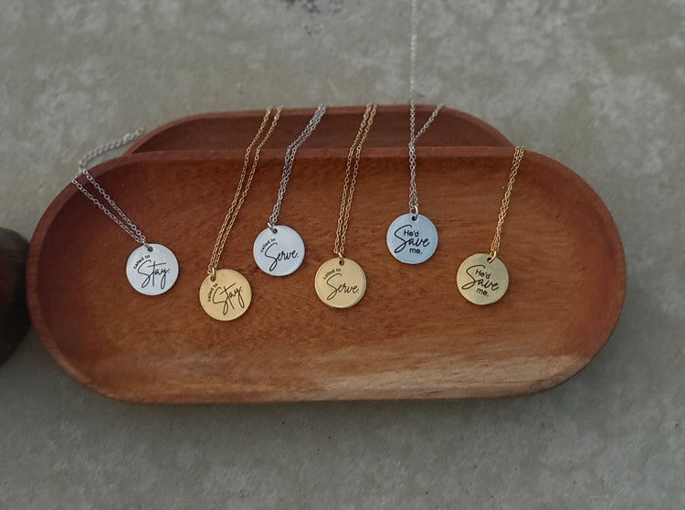 silver necklace that says He'd Save Me with a floral painted Book of Mormon in the background