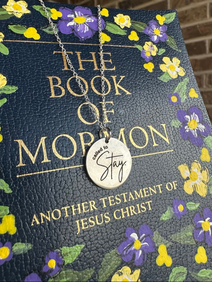 Necklace with a 'Called to Stay' pendant on a 'Book of Mormon' with floral design