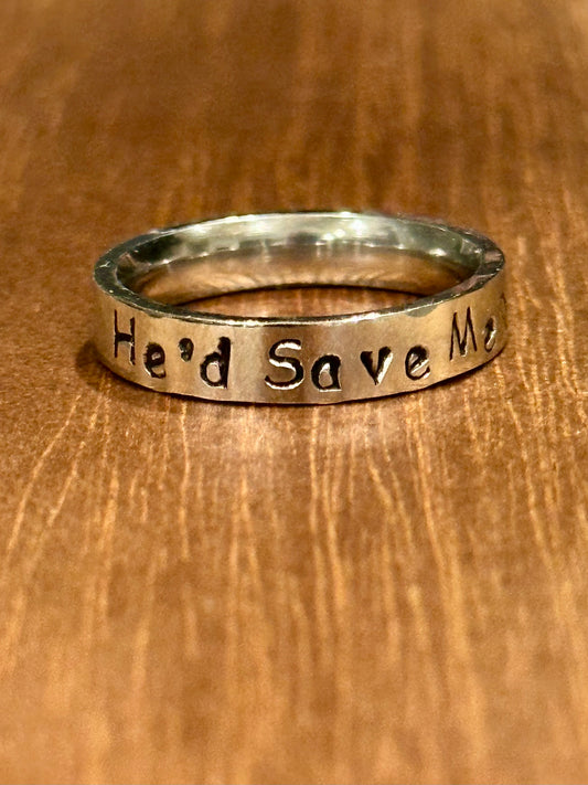 Silver ring with 'He'd Save Me' engraving on a wooden surface