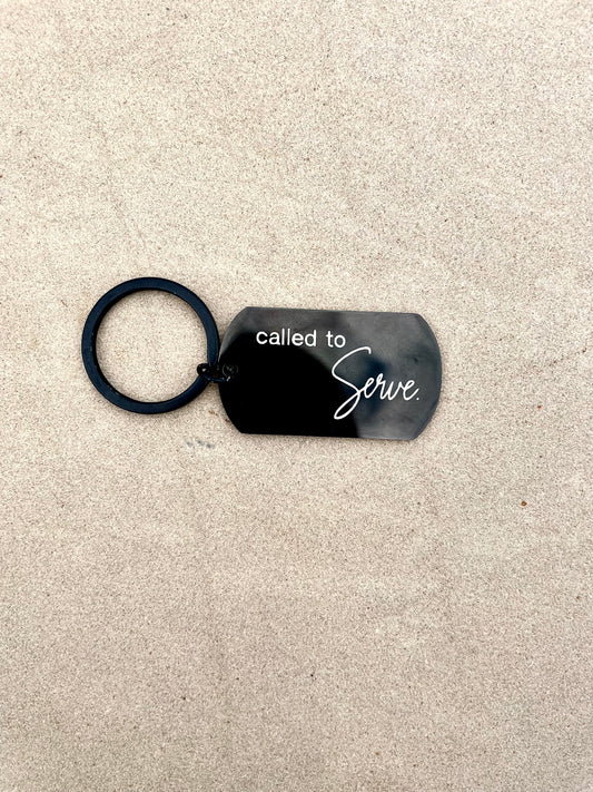 Black keychain that says 'Called to Serve.'