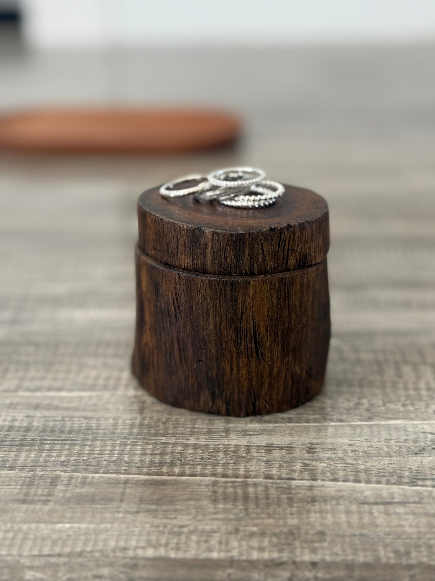Silver accent rings on a wooden block.