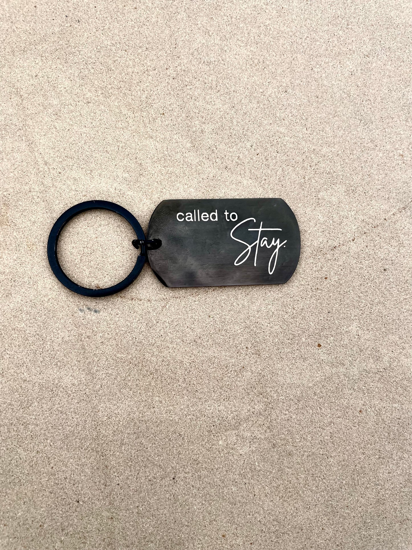 Black keychain that says 'Called to Stay'